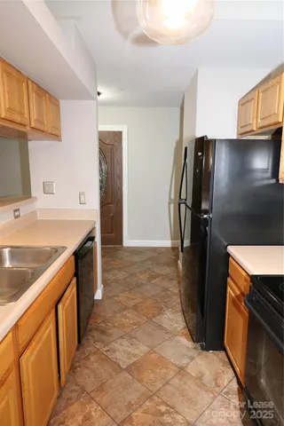 a kitchen with stainless steel appliances granite countertop a refrigerator and a sink
