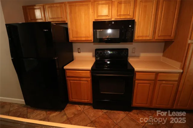 a kitchen with a refrigerator and a stove