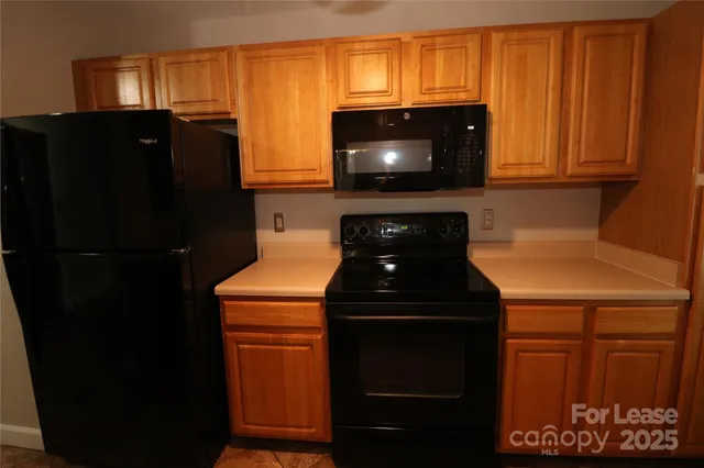 a kitchen with a refrigerator and a microwave