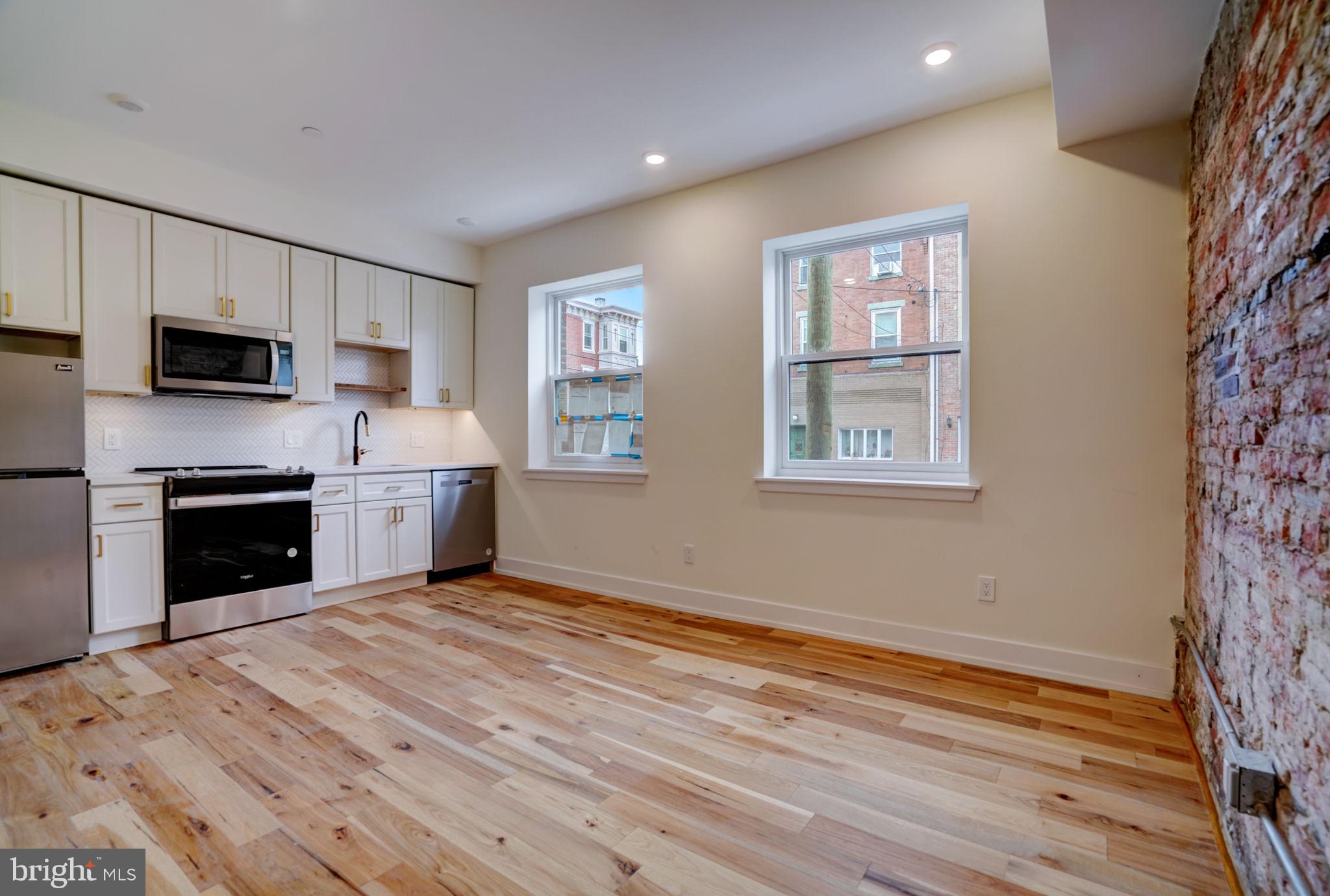 620 South 8th Street Philadelphia, PA 19147 - Photo 5 of 12 a view of kitchen with microwave stove top oven and cabinets