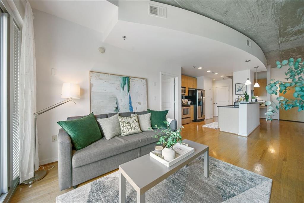 a living room with furniture and wooden floor