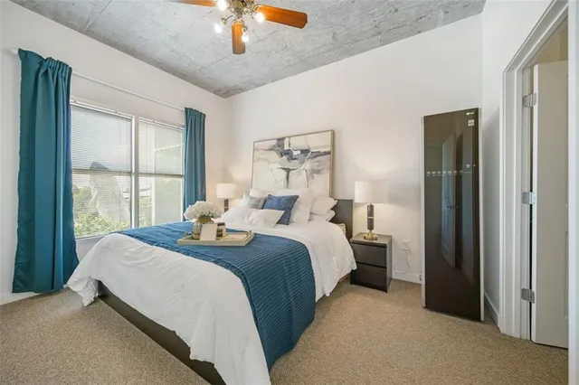 a bedroom with bed and window