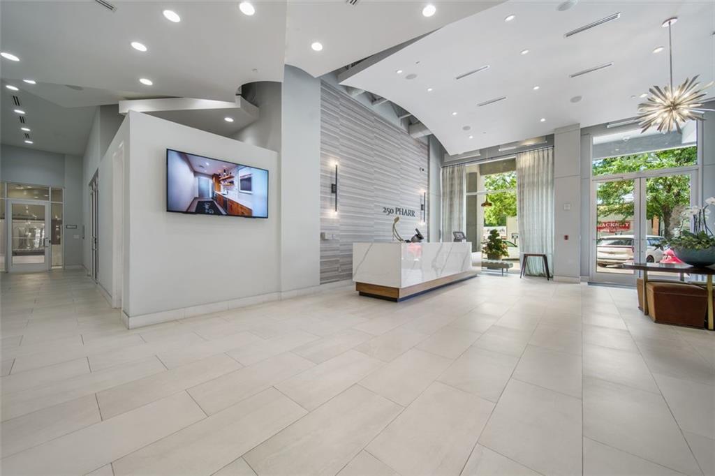 250 Pharr Road Northeast, Unit 412 Atlanta, GA 30305 - Photo 21 of 49 a view of hallway with furniture and a large window
