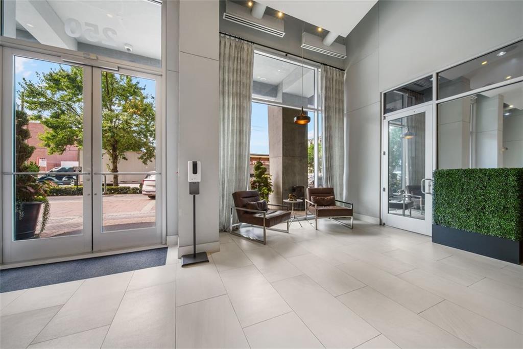 250 Pharr Road Northeast, Unit 412 Atlanta, GA 30305 - Photo 22 of 49 a view of a lobby with chair and floor to ceiling window