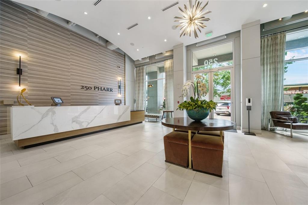 250 Pharr Road Northeast, Unit 412 Atlanta, GA 30305 - Photo 24 of 49 a living room with furniture and a potted plant