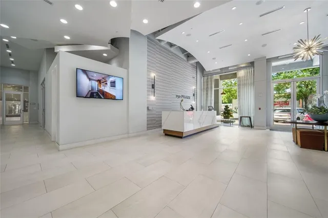 a view of hallway with furniture and a large window