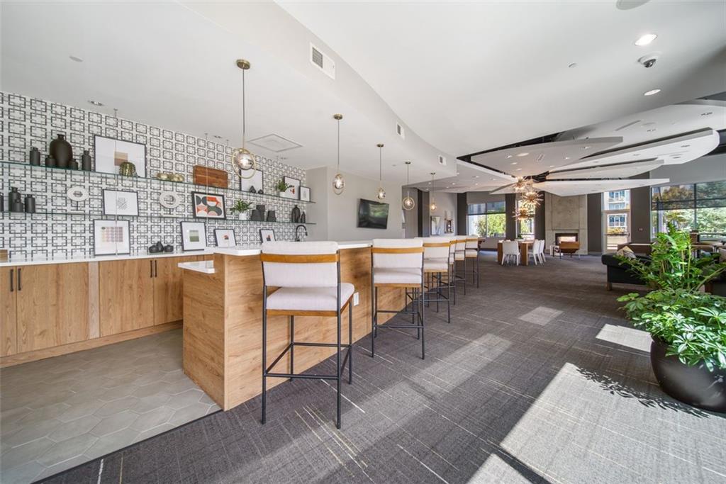 250 Pharr Road Northeast, Unit 412 Atlanta, GA 30305 - Photo 27 of 49 a living room with lots of furniture and a chandelier