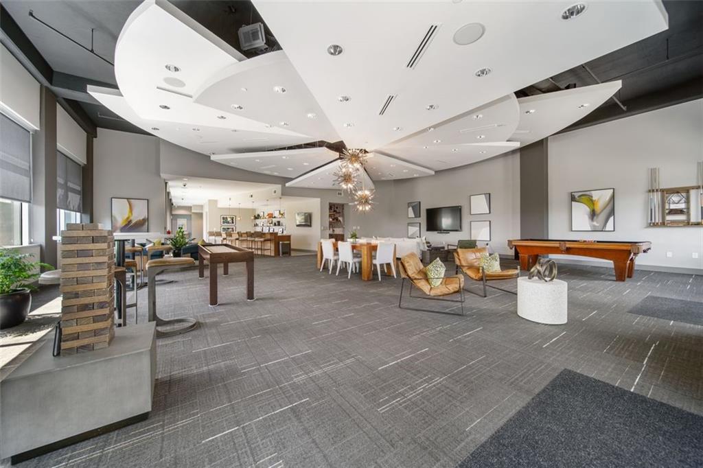 250 Pharr Road Northeast, Unit 412 Atlanta, GA 30305 - Photo 29 of 49 a room with gym equipment and a large window