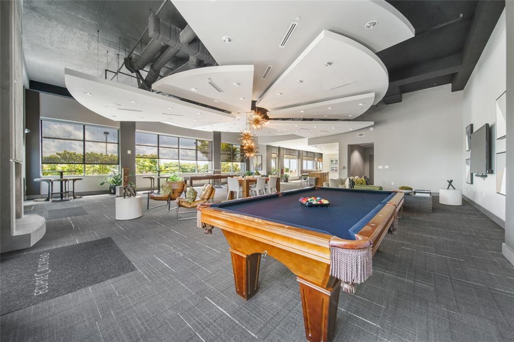 250 Pharr Road Northeast, Unit 412 Atlanta, GA 30305 - Photo 30 of 49 a room with lots of furniture and lots of windows