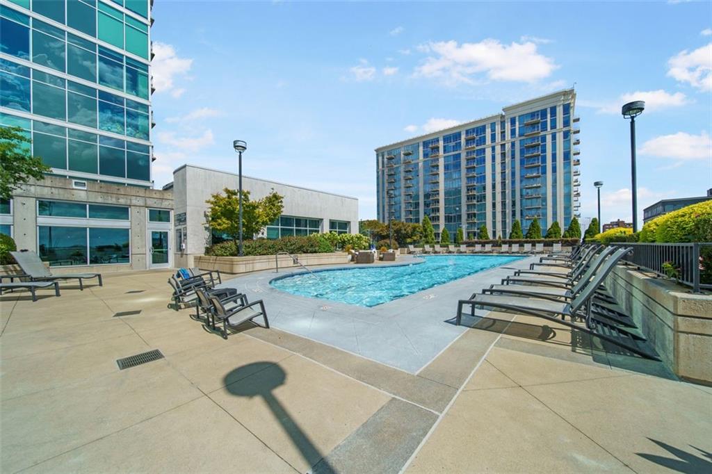 250 Pharr Road Northeast, Unit 412 Atlanta, GA 30305 - Photo 31 of 49 a view of a patio with a table and chairs