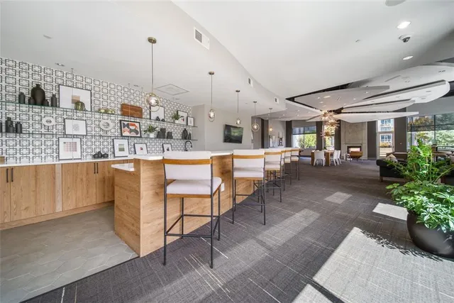 a living room with lots of furniture and a chandelier
