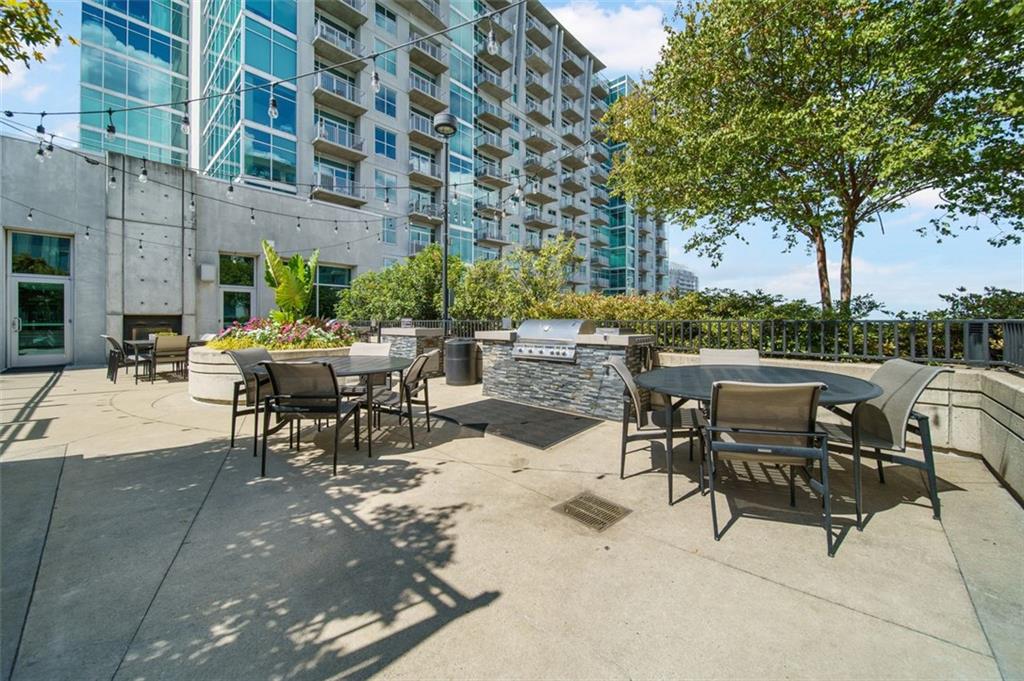 250 Pharr Road Northeast, Unit 412 Atlanta, GA 30305 - Photo 33 of 49 a view of a patio with a table and chairs