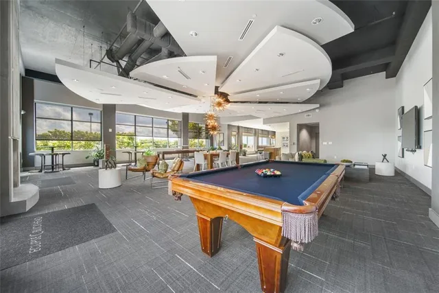 a room with lots of furniture and lots of windows