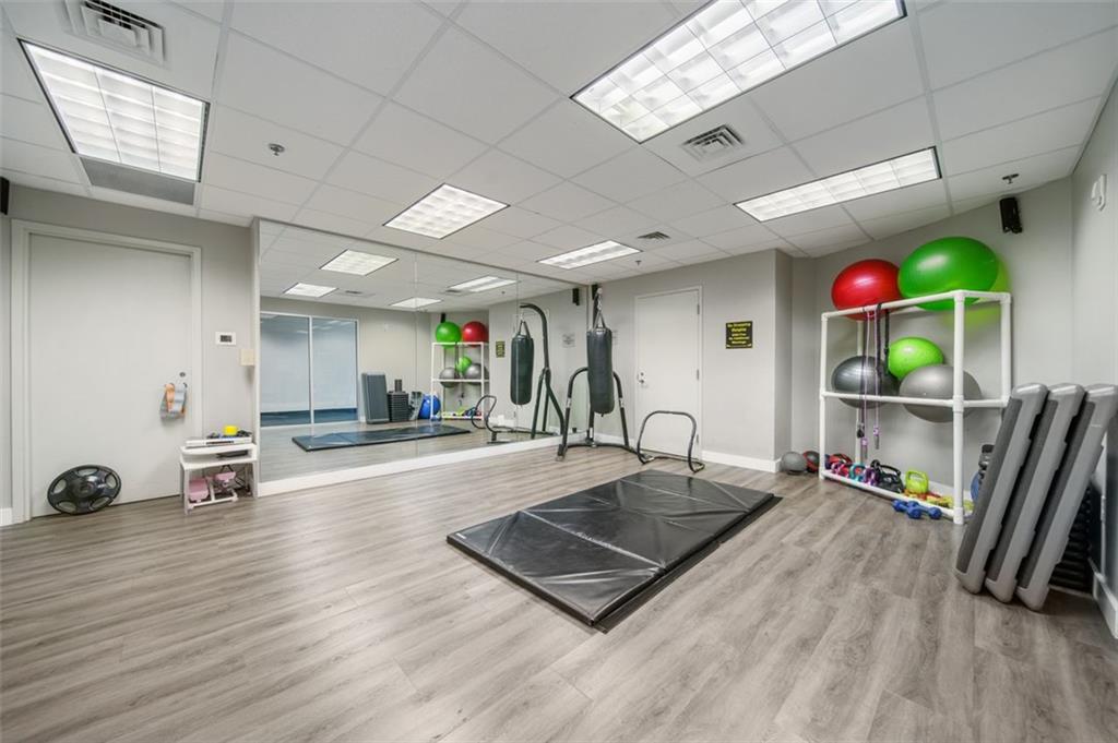 250 Pharr Road Northeast, Unit 412 Atlanta, GA 30305 - Photo 36 of 49 a room with lots of furniture and a flat screen tv