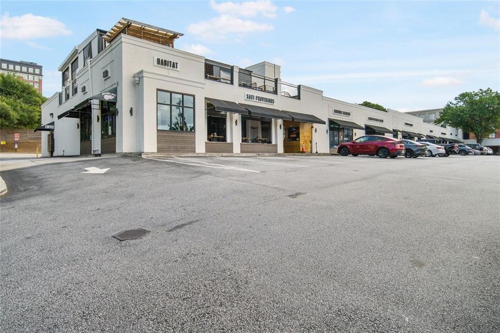 250 Pharr Road Northeast, Unit 412 Atlanta, GA 30305 - Photo 44 of 49 a front view of a building with lot of cars and trees