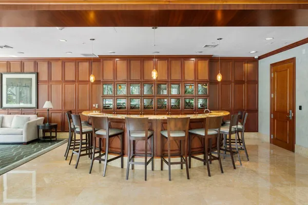 a dining room with furniture a chandelier and a rug