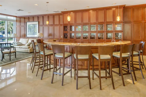 a view of a dining room with furniture and a chandelier