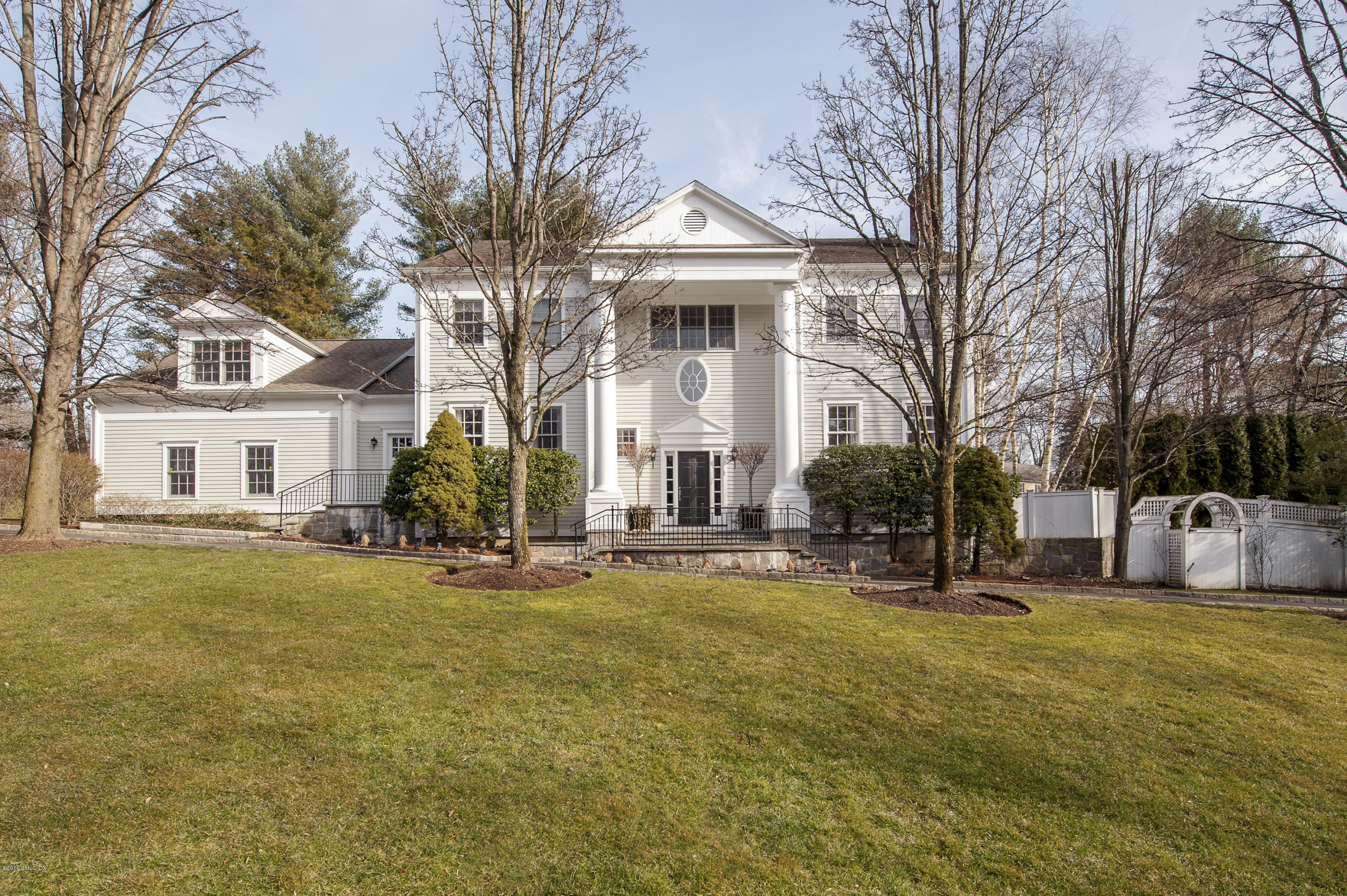 175 Stanwich Road Greenwich, CT 06830 - Photo 1 of 21 a front view of a house with a yard and garage