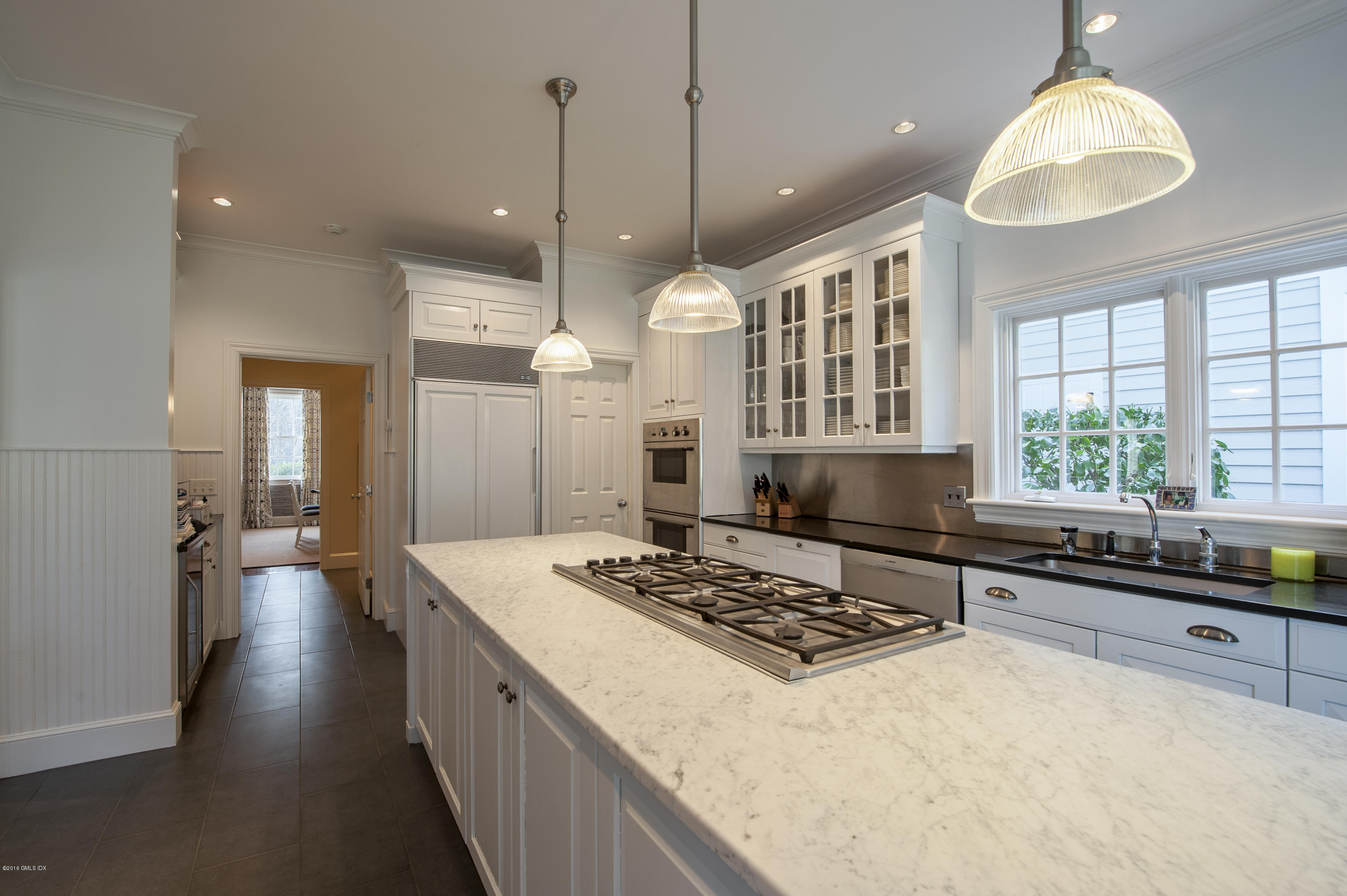 175 Stanwich Road Greenwich, CT 06830 - Photo 7 of 21 a kitchen with a stove a window and chairs