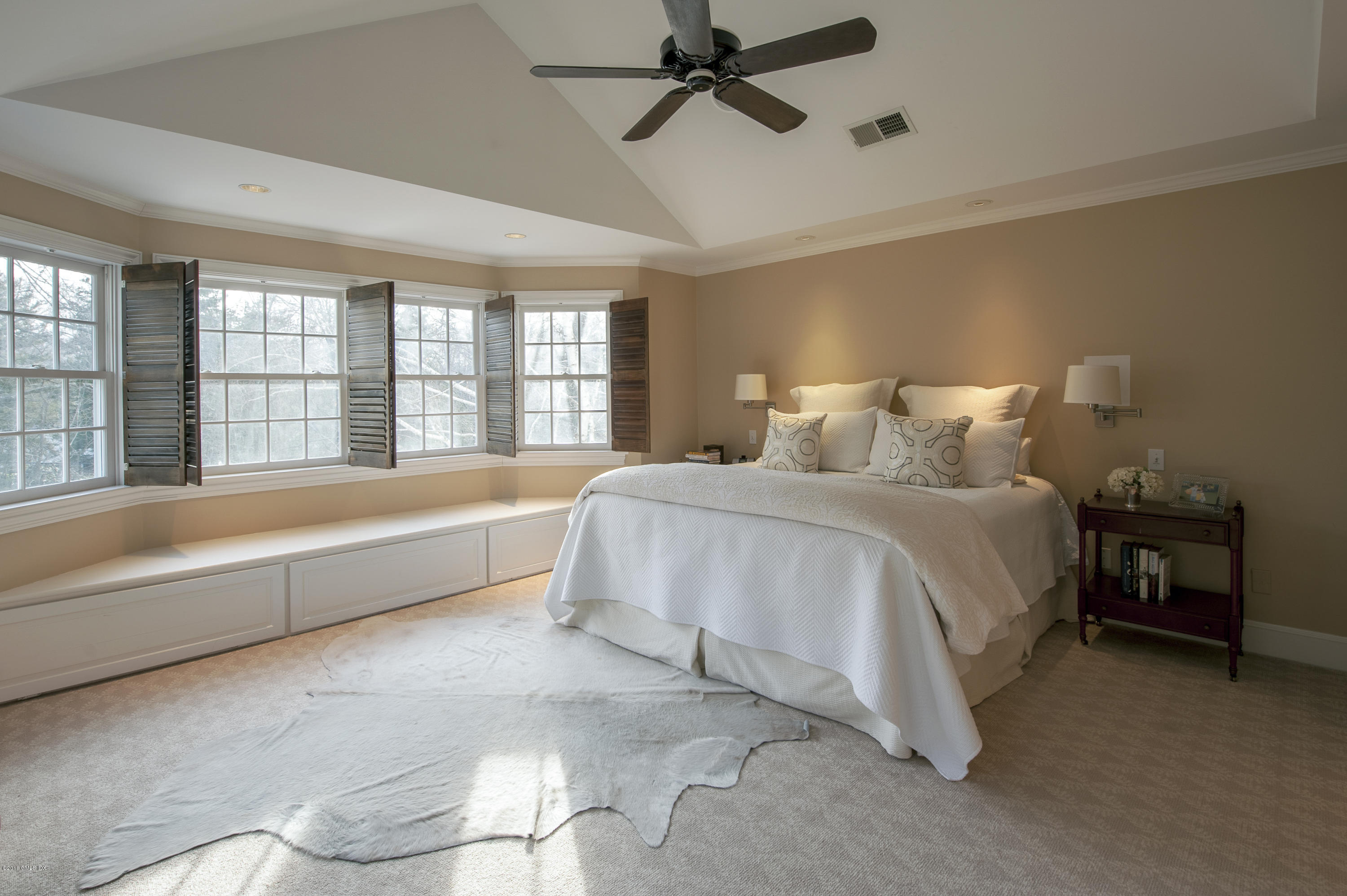 175 Stanwich Road Greenwich, CT 06830 - Photo 9 of 21 a spacious bedroom with a bed and a chandelier