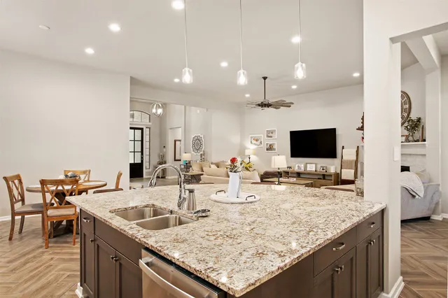 a kitchen with granite countertop a sink and a table