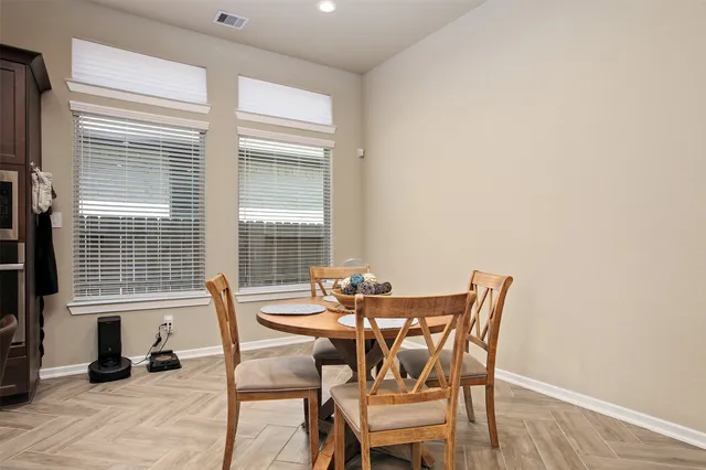 a view of a dining room with furniture and windows