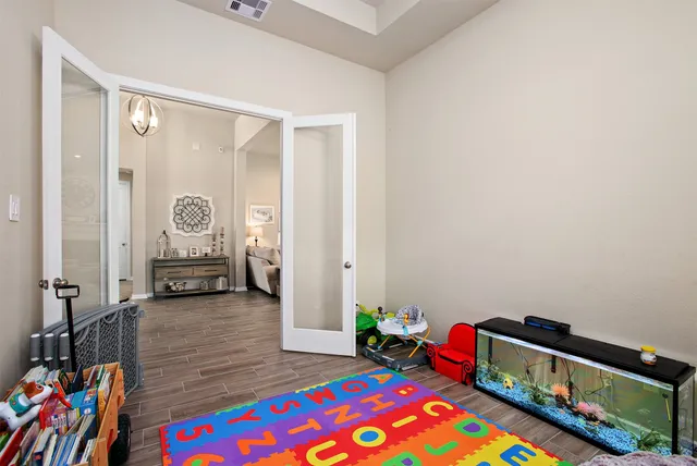 a living room with furniture and a book shelf