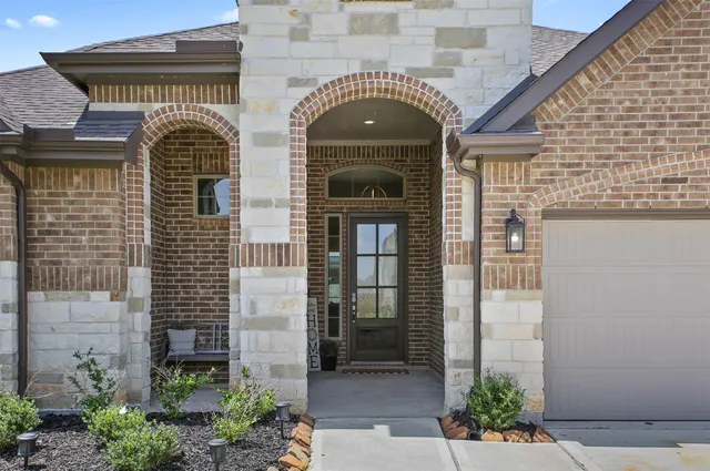a front view of a house with plants