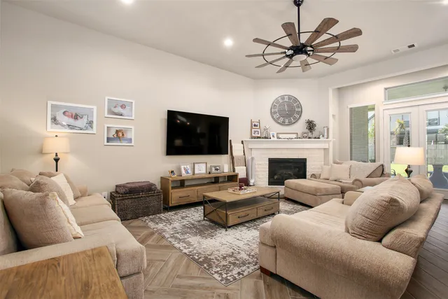 a living room with furniture a fireplace and a flat screen tv