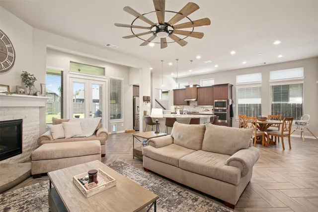 a living room with furniture kitchen and a chandelier