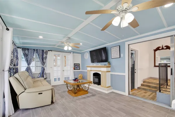 a living room with furniture a fireplace and a flat screen tv