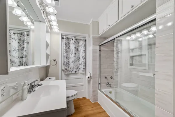 a bathroom with a tub sink and mirror