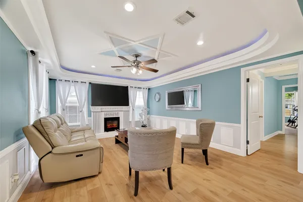 a living room with furniture a fireplace and a flat screen tv