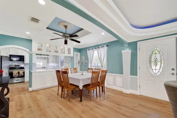 a view of a dining room with furniture window and wooden floor