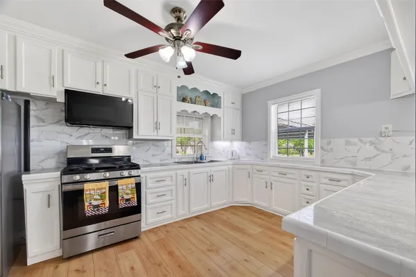a kitchen with stainless steel appliances granite countertop a stove and a sink