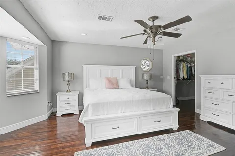 a bathroom with a granite countertop sink a mirror and shower