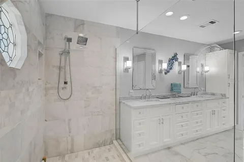 a bathroom with a granite countertop sink a toilet and a mirror