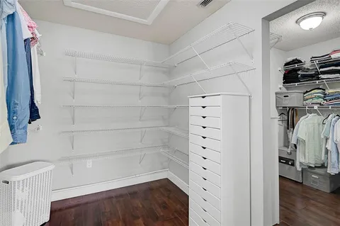 a bedroom with a large bed wooden floor and window