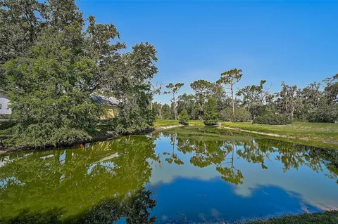 a swimming pool with outdoor seating and yard