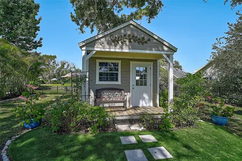 an aerial view of residential houses with outdoor space and trees