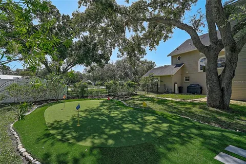 an aerial view of a house with yard swimming pool and outdoor seating
