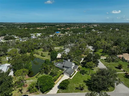 an aerial view of a house with a yard