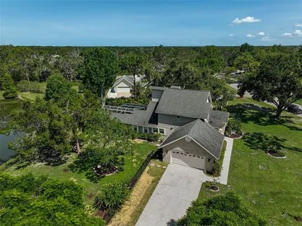 a front view of a house with yard and green space