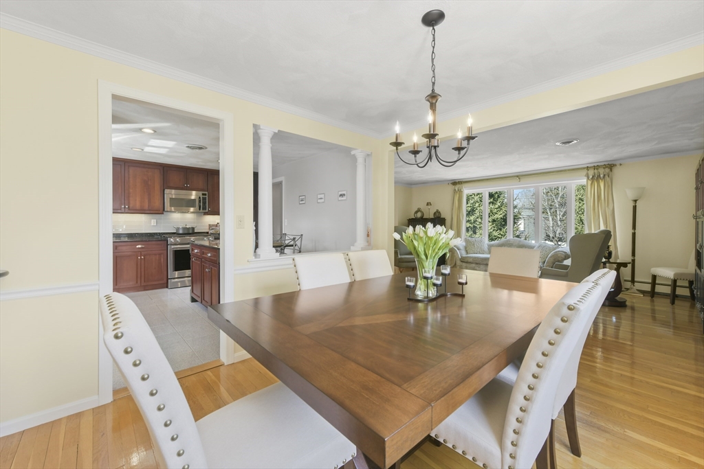 4 Coach Lane Dedham, MA 02026 - Photo 12 of 32 a dining room with furniture a chandelier and wooden floor