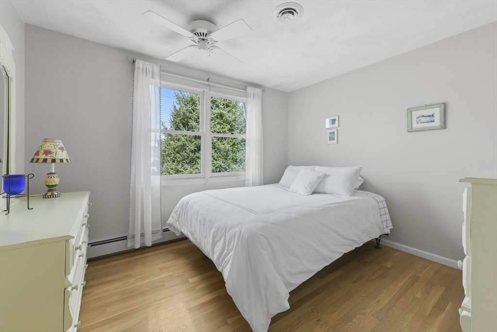 4 Coach Lane Dedham, MA 02026 - Photo 16 of 32 a bedroom with a bed and a window