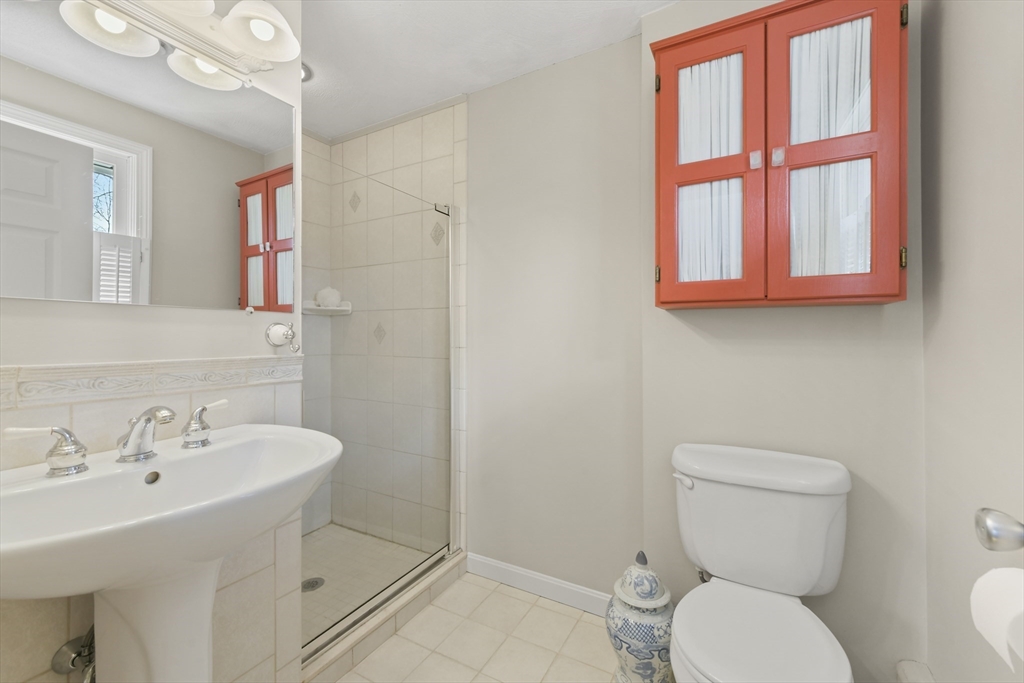 4 Coach Lane Dedham, MA 02026 - Photo 19 of 32 a white toilet sitting next to a bathroom sink