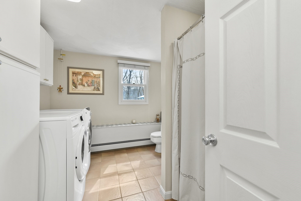 4 Coach Lane Dedham, MA 02026 - Photo 20 of 32 a bathroom with a tub and a shower