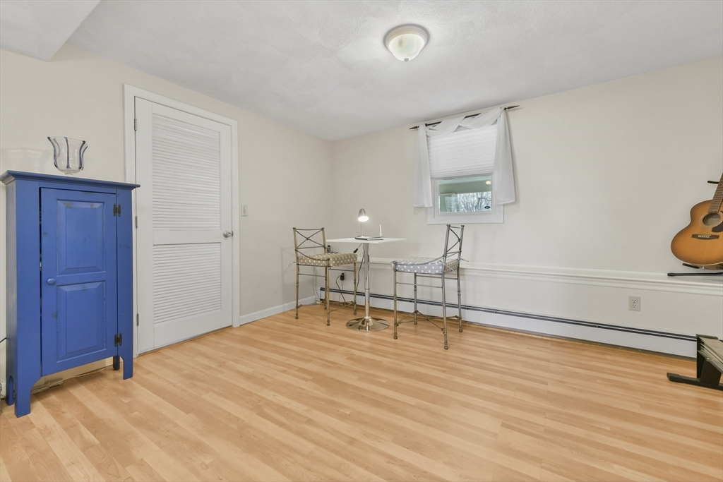 4 Coach Lane Dedham, MA 02026 - Photo 23 of 32 a room with wooden floor and furniture