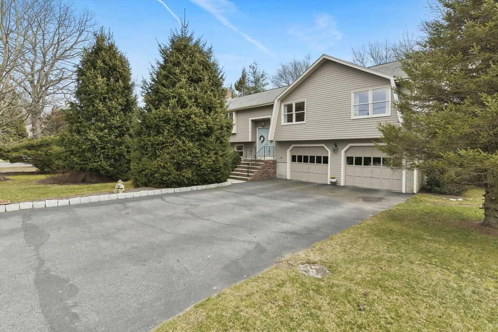 4 Coach Lane Dedham, MA 02026 - Photo 25 of 32 a view of a house with a backyard