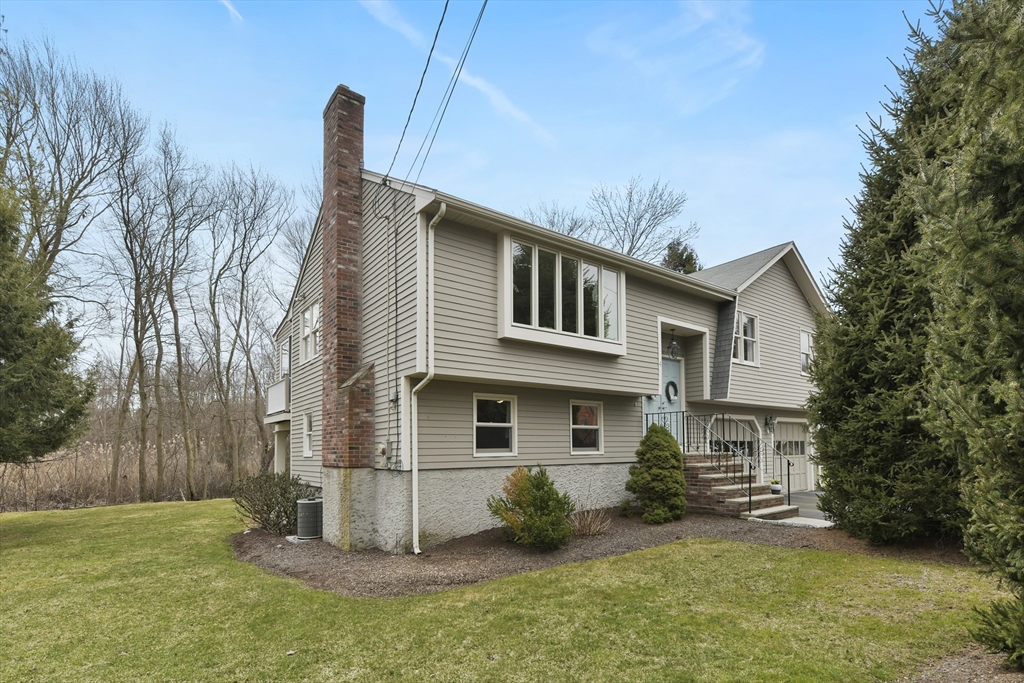 4 Coach Lane Dedham, MA 02026 - Photo 27 of 32 a front view of a house with a yard
